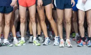 Runners at the start line preparing for a run to slim their legs