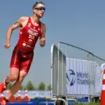 Triathlete running during the final leg of an Ironman vs triathlon race