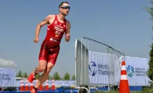 Triathlete running during the final leg of an Ironman vs triathlon race