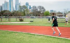 Runner performing interval training on a track to improve speed and endurance