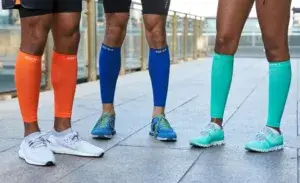 Group of runners wearing colorful compression sleeves for shins before a workout