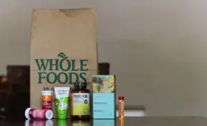 Assorted vitamin and supplement products from Whole Foods displayed on a table – representing good vitamins for runners focused on natural health