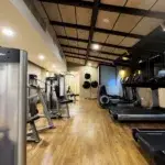 Treadmill vs outdoor running – modern indoor gym with Life Fitness treadmills and strength equipment