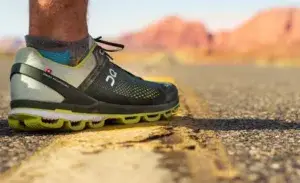 Running shoes on an open road during a long run workout for marathon training, showcasing endurance and preparation.