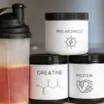 Pre workout 101 essentials – shaker bottle with creatine, protein, and pre-workout supplements on a countertop