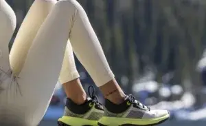 Runner resting with legs elevated during runner's knee recovery outdoors.