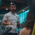 Running coach in Canberra giving one-on-one guidance at an indoor training session.