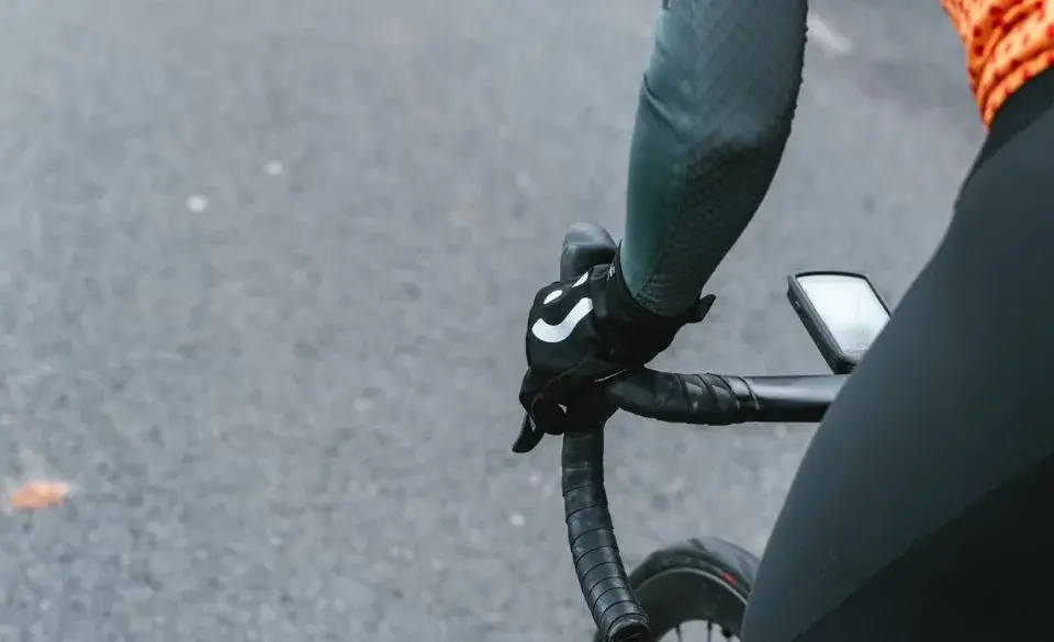 Close-up of cyclist using power meter for wattage comparison stationary bike to race bike analysis