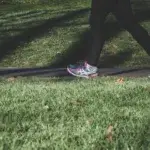 Person walking in running shoes representing average speed human during daily activity.
