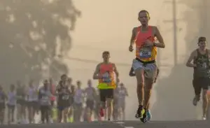Runners during a marathon at sunrise, illustrating how many steps are in a marathon.