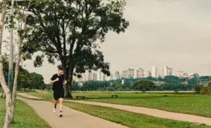 Runner training outdoors on a path, demonstrating ideal running cadence based on height.