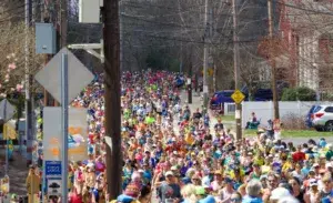 Large crowd of runners crossing the marathon start line, showcasing the need for accurate marathon timing systems.