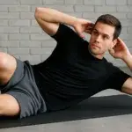 Obliquus externus exercise being performed with a side crunch on a mat.