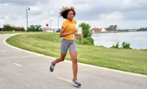Woman running 3km every day on a path by the water.