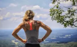 Runner catching breath after a tempo run overlooking scenic valley