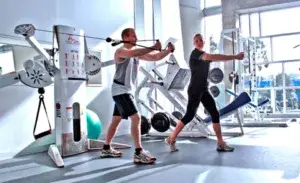 Chest exercises with cables using single-arm cable fly in the gym