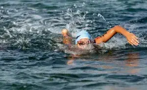 Triathlete swimming in open water during the 70.3 swim distance