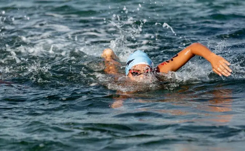 Triathlete swimming in open water during the 70.3 swim distance
