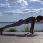 Runner performing plank outdoors near water as part of the best core exercises for runners