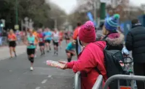 Best Marathons in Australia runners passing cheering supporters.