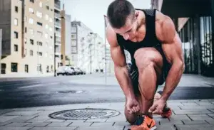 Athlete preparing for a run in the city highlighting running benefits for men.