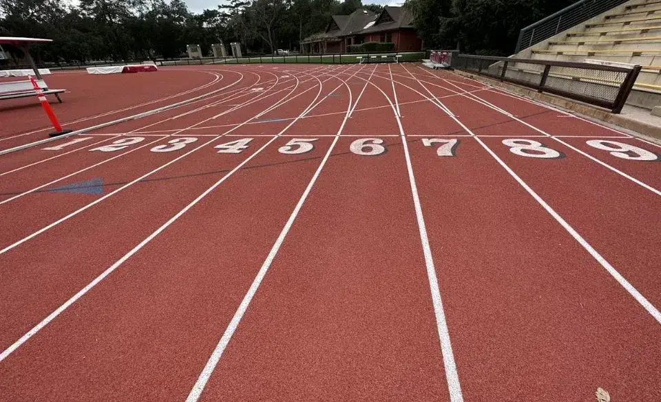 Running coach rates Australia – view of athletics track lanes showing starting positions