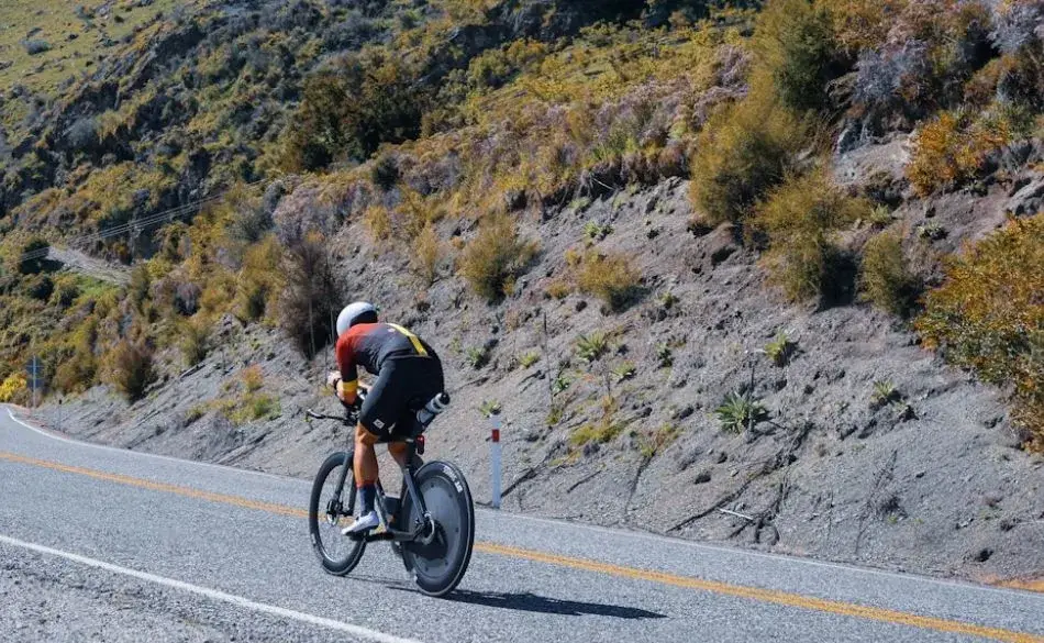 Cyclist climbing a steep mountain road during the Toughest Ironman in the World