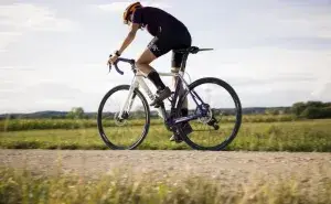 Cyclist pedaling outdoors while focusing on the best cadence for cycling