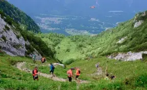 Runners climbing steep trails in the mountains during one of the hardest marathons in the US