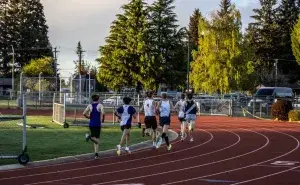 Runners doing interval training for 10km run on outdoor track