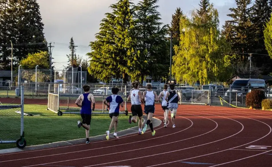 Runners doing interval training for 10km run on outdoor track