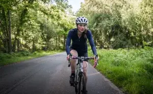 Cyclist on the road experiencing lower back pain cycling