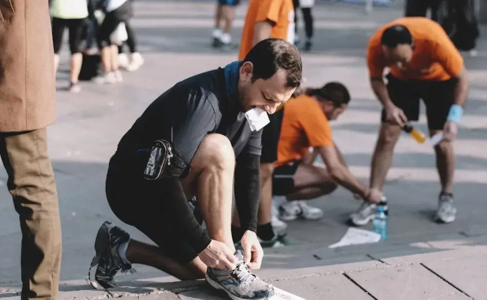 marathon running coach helping runners prepare for race