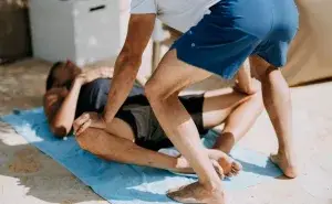 stretches for cyclists with partner-assisted hip stretch on mat