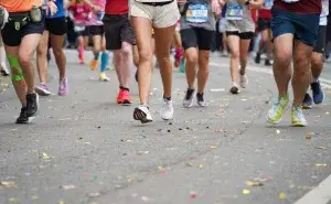 Runners crossing the finish line after completing an 11 weeks to train for a half marathon program