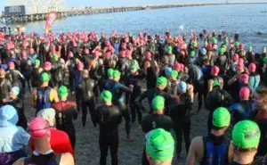 Triathletes line up for the swim start during a world-class Half Ironman event