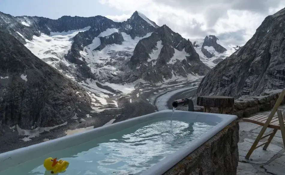 How cold should an ice bath be for recovery, showing a mountain ice bath setup with freezing water and a peaceful endurance training atmosphere.