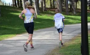 mum and son jogging slowly together showing that slow running is not bad for knees