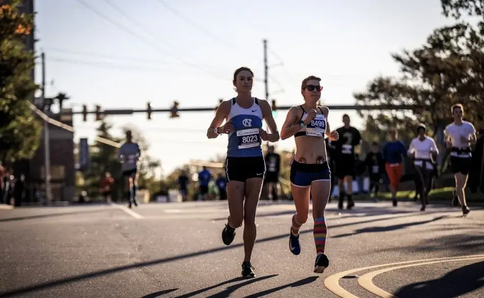 Two runners maintaining their marathon run pace during a city race