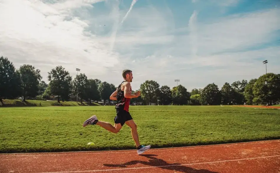 Runner performing marathon workouts on an outdoor track to build endurance and pacing control.