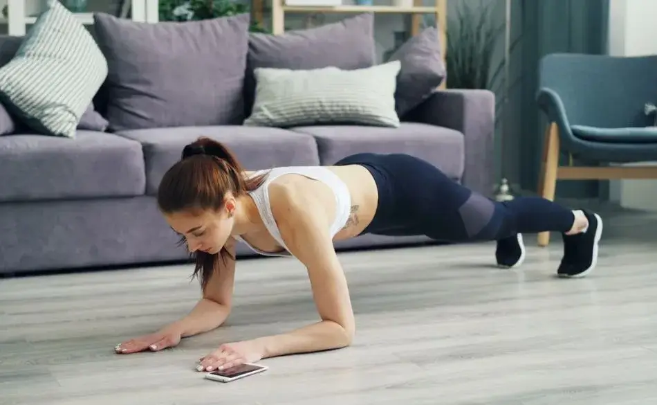 Woman performing a plank as part of strength training for triathletes at home to build core stability and endurance