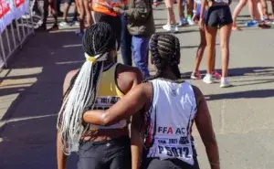 Runners supporting each other after a race, highlighting the community and motivation behind the 10 benefits of running.