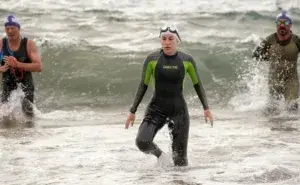 affordable triathlon coach online athlete exiting the water during a triathlon swim