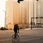 Cyclist riding at sunrise showing the benefits of cycling in the morning