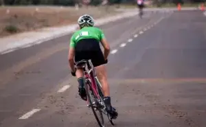 cyclist riding on the road with strong glute engagement demonstrating the best glute exercises for cyclists in action
