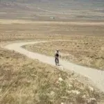 Cyclist riding a remote gravel trail, part of the best gravel races worth traveling for.