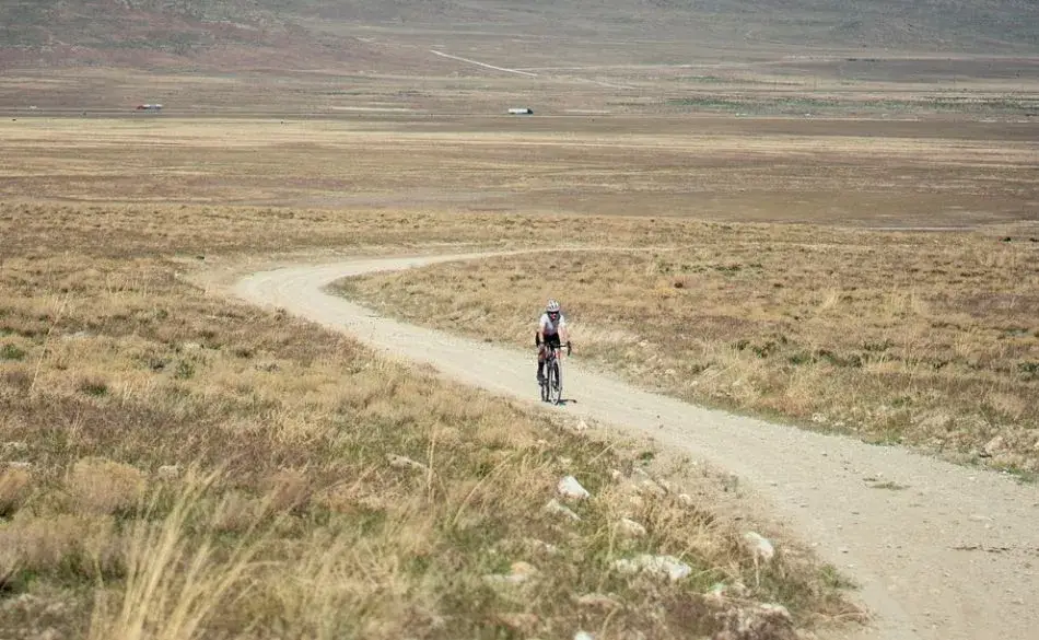 Cyclist riding a remote gravel trail, part of the best gravel races worth traveling for.