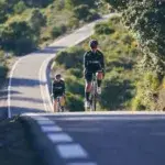 Cyclists climbing a mountain road during the Haute Route Cycling Event, capturing the endurance, focus, and scenery that define this world-class multi-day cycling challenge.