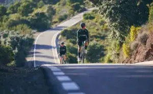 Cyclists climbing a mountain road during the Haute Route Cycling Event, capturing the endurance, focus, and scenery that define this world-class multi-day cycling challenge.