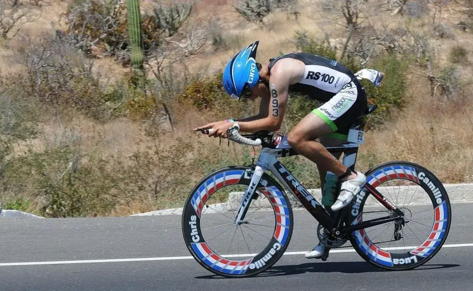 Triathlete cycling in aero position showing how to improve cycling speed for triathlon